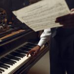 Black pianist with music notebook in his hands