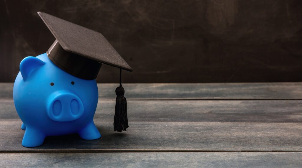 Education school cost, scholarship, student loan. Piggy bank with graduation cap