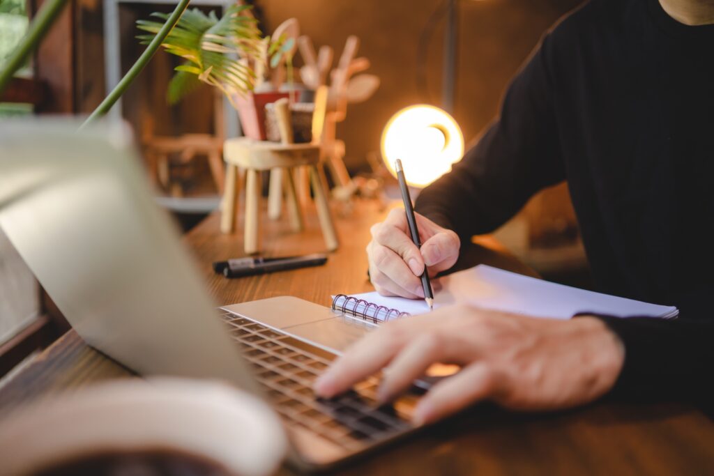 people hand holding a pen for working to write on a book for letter or business document