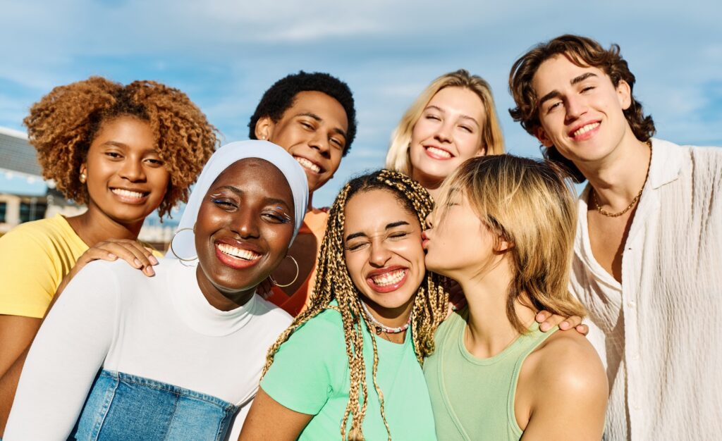 Young people of multiples cultures embracing and smiling